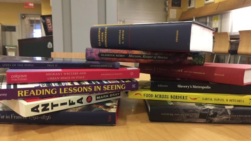Pile of newly published books by Dartmouth authors
