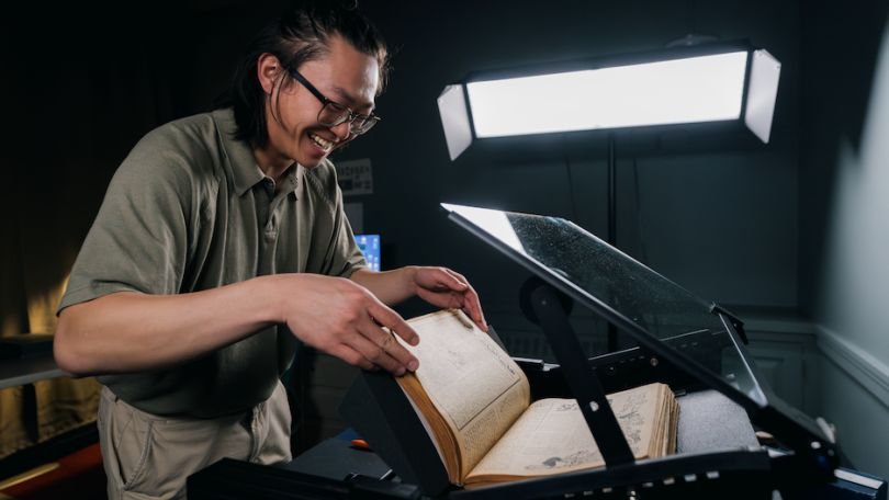 Daniel Lin '23 digital by dartmouth library student fellow working to digitize an old magazine